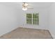 Bedroom with neutral carpet, ceiling fan, and a window with natural light at 4418 Coventry Row Ct, Charlotte, NC 28270