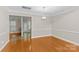 Spacious dining room with hardwood floors, neutral walls, and modern light fixture at 4418 Coventry Row Ct, Charlotte, NC 28270