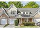 Charming townhouse with a brick and light yellow siding, attached garages, and well-maintained landscaping at 4418 Coventry Row Ct, Charlotte, NC 28270