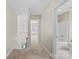 Hallway with carpet leading to rooms with views of bedroom and bathroom at 4418 Coventry Row Ct, Charlotte, NC 28270