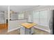Bright kitchen nook with tile flooring, wooden island, and large windows at 4418 Coventry Row Ct, Charlotte, NC 28270