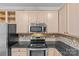 Well-equipped kitchen features stainless steel appliances, granite countertops, and classic cabinetry at 4418 Coventry Row Ct, Charlotte, NC 28270