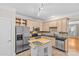 Spacious kitchen with stainless steel appliances, central island, and tile backsplash at 4418 Coventry Row Ct, Charlotte, NC 28270