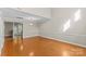 Spacious room boasts hardwood floors, neutral walls, and ample natural light at 4418 Coventry Row Ct, Charlotte, NC 28270