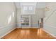 Bright living room featuring hardwood floors, a large window, and neutral wall paint at 4418 Coventry Row Ct, Charlotte, NC 28270