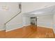 Open living area showcasing hardwood floors, high ceilings, and a modern lighting fixture at 4418 Coventry Row Ct, Charlotte, NC 28270