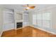 Well-lit living room featuring hardwood floors, a fireplace, and built-in shelving at 4418 Coventry Row Ct, Charlotte, NC 28270