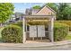 Community mailboxes sit beneath a wooden pergola in a residential neighborhood with lush landscaping at 4418 Coventry Row Ct, Charlotte, NC 28270