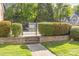 Community pool gate surrounded by well-maintained landscaping and stone accents at 4418 Coventry Row Ct, Charlotte, NC 28270