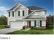 Charming two-story home with a two-car garage, stone accents, and teal shutters against light beige siding at 4561 Family Trail Dr, Indian Land, SC 29707