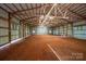 Inside the metal barn, bright light accents the expansive open space, ready for various uses at 4979 Plateau Rd, Vale, NC 28168