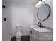 Modern bathroom with marble countertop vanity, black fixtures, and a walk-in shower at 4979 Plateau Rd, Vale, NC 28168