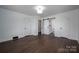 Bright bedroom featuring dark wood floors, white trim and easy access to the bathroom at 4979 Plateau Rd, Vale, NC 28168