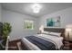 Bedroom featuring neutral tones, large window, with a gray bed with blue blanket and modern decor at 4979 Plateau Rd, Vale, NC 28168