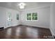 Bright bedroom featuring hardwood floors, white trim and multiple windows for natural light at 4979 Plateau Rd, Vale, NC 28168