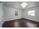 Bright bedroom featuring dark wood floors, white trim and natural light at 4979 Plateau Rd, Vale, NC 28168