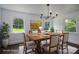 Dining area featuring a modern chandelier, hardwood floors, and natural light from the surrounding windows at 4979 Plateau Rd, Vale, NC 28168