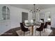 Dining room is staged with a glass table, seating for six, and decorative rug at 4979 Plateau Rd, Vale, NC 28168