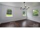 Bright dining room features hardwood floors, white walls, and modern chandelier lighting at 4979 Plateau Rd, Vale, NC 28168