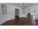 Open dining room with hardwood floors, white walls, and built-in cabinets at 4979 Plateau Rd, Vale, NC 28168