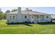 Charming home exterior featuring a brick facade, covered front porch, and well-maintained landscaping at 4979 Plateau Rd, Vale, NC 28168