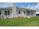 A lovely ranch-style home with a white brick exterior and an inviting front porch at 4979 Plateau Rd, Vale, NC 28168
