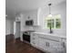 Modern kitchen boasts stainless appliances, white shaker cabinets, and a farmhouse sink at 4979 Plateau Rd, Vale, NC 28168