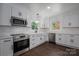 Modern kitchen with stainless steel appliances, white cabinetry and natural light at 4979 Plateau Rd, Vale, NC 28168