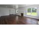 Bright living room showcasing hardwood floors, a fireplace, and large windows offering great natural light at 4979 Plateau Rd, Vale, NC 28168