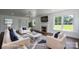 Staged living room featuring hardwood floors, a fireplace, and bright windows with views of the outdoors at 4979 Plateau Rd, Vale, NC 28168