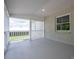 Covered patio with painted brick walls and large windows that overlook an outdoor greenery area at 4979 Plateau Rd, Vale, NC 28168