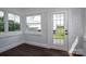 Bright sunroom featuring hardwood floors, white brick and multiple windows for natural light at 4979 Plateau Rd, Vale, NC 28168