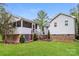 The backyard has green grass, a deck with stairs, and a house with light gray siding at 4989 Post Oak Ln, Rock Hill, SC 29732
