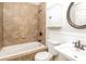 Bathroom features tile walls, a tub, a toilet, and a sink with a round mirror above at 4989 Post Oak Ln, Rock Hill, SC 29732