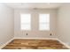 Bright bedroom featuring hardwood floors, two windows, and neutral wall paint at 4989 Post Oak Ln, Rock Hill, SC 29732