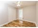 Cozy bedroom showcasing hardwood floors, a ceiling fan, and a double door closet at 4989 Post Oak Ln, Rock Hill, SC 29732