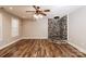 Spacious living room boasts unique rock fireplace, wood floors and ample natural light at 4989 Post Oak Ln, Rock Hill, SC 29732