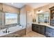 Well-lit bathroom featuring a soaking tub, shower, and a gray vanity with a white countertop at 5380 Pembrey Dr # Lot 26, Denver, NC 28037
