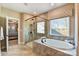 Bathroom featuring a glass shower, soaking tub, and a view through a window at 5380 Pembrey Dr # Lot 26, Denver, NC 28037