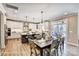 Modern dining area with a large table, pendant lighting, and view of the island kitchen and outdoor space at 5380 Pembrey Dr # Lot 26, Denver, NC 28037