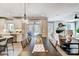 Dining area with a hanging light, open to the kitchen, living room, and sliding glass door to the outdoors at 5380 Pembrey Dr # Lot 26, Denver, NC 28037