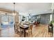 Open dining space with a hanging light, connecting to a living area, kitchen, and outdoor patio with a swing at 5380 Pembrey Dr # Lot 26, Denver, NC 28037
