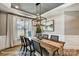 Beautiful dining room with modern chandelier, table runner, neutral walls and view of outdoors at 5380 Pembrey Dr # Lot 26, Denver, NC 28037