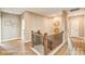 Hallway with wood-look flooring, oak staircase, and decorative wall art at 5380 Pembrey Dr # Lot 26, Denver, NC 28037
