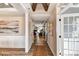 Inviting hallway showcasing wood floors, detailed trim, and an open view to the living room with a fireplace at 5380 Pembrey Dr # Lot 26, Denver, NC 28037