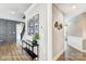 Inviting hallway with decorative wall paneling, a console table with plant, and a gallery wall with framed photos at 5380 Pembrey Dr # Lot 26, Denver, NC 28037