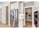 Modern kitchen area with stainless steel refrigerator and pantry, featuring white cabinetry and tiled backsplash at 5380 Pembrey Dr # Lot 26, Denver, NC 28037