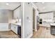 Elegant kitchen area with white cabinetry, wine cooler, and stainless steel appliances at 5380 Pembrey Dr # Lot 26, Denver, NC 28037