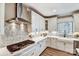 Well-lit kitchen with white cabinets, a gas stovetop, mosaic backsplash, and modern fixtures and finishes at 5380 Pembrey Dr # Lot 26, Denver, NC 28037