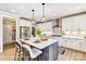 Bright kitchen featuring white cabinets, stainless steel appliances, an island with bar seating, and modern pendant lighting at 5380 Pembrey Dr # Lot 26, Denver, NC 28037